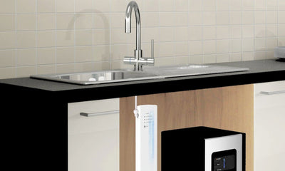 Space-saving under sink water filtration system installed in a modern kitchen.